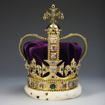 A gold crown set diamonds, rubies, amethysts and sapphires. It has a purple velvet cap.