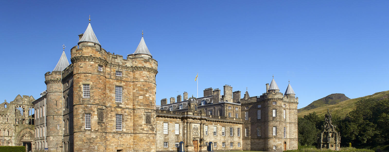 Image of Palace of Holyroodhouse with Holyrood Park  and Arthurs seet in background 