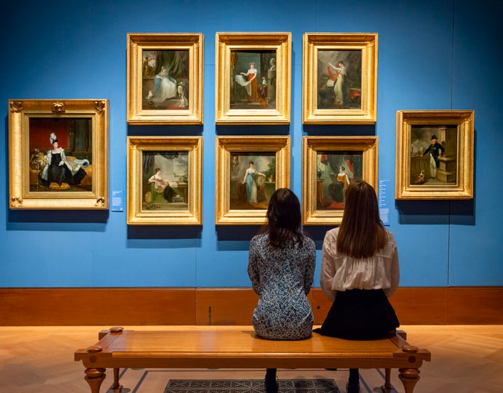 Visitors from. behind in Queen's Gallery looking at paintings