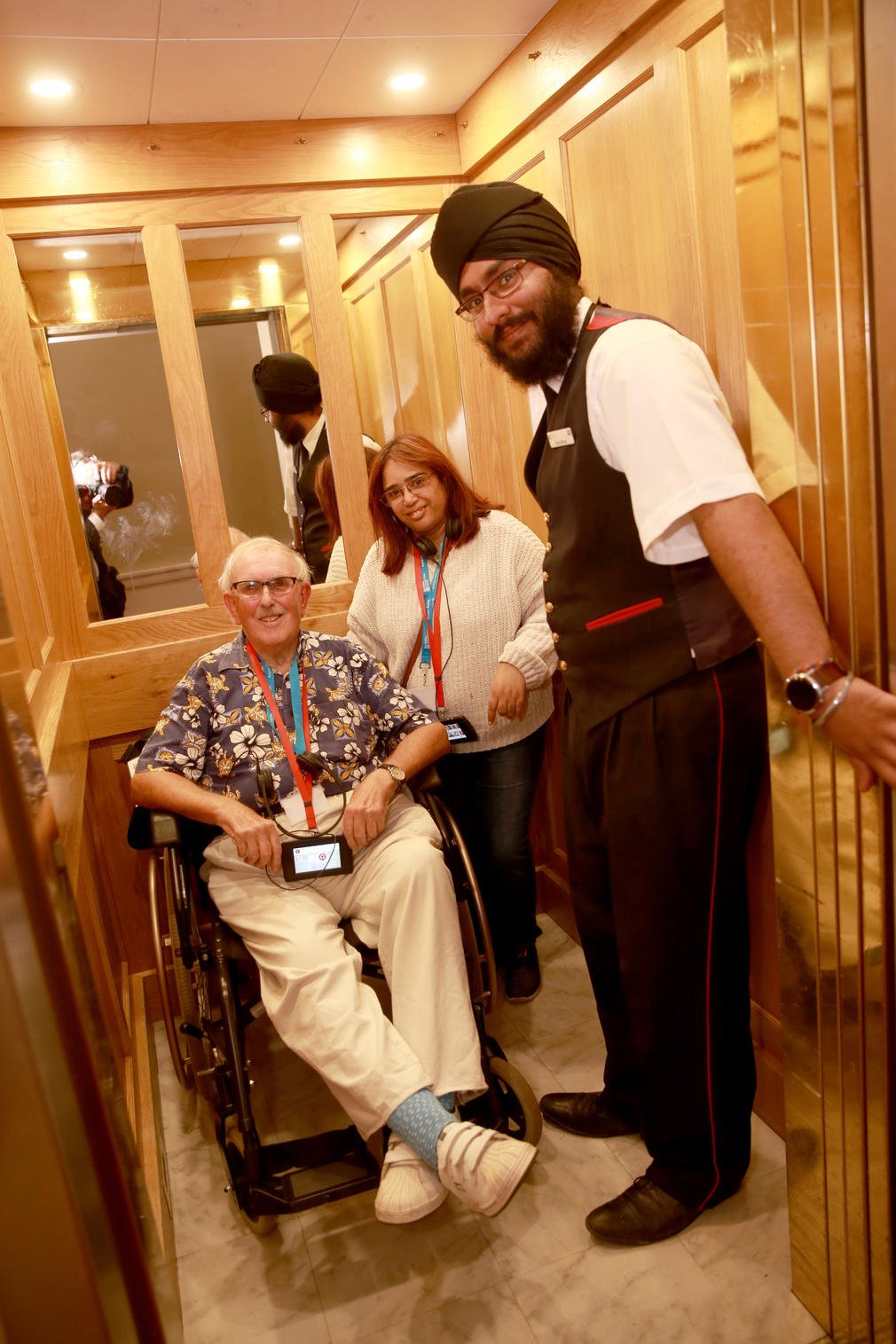 Visitors using the lift in the State Rooms of Buckingham Palace