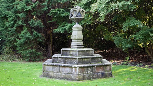 A sun dial on a lawn