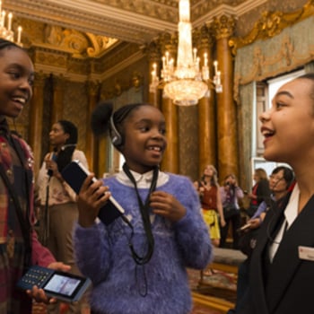 A Warden talking about the multimedia guide during the Summer Opening of Buckingham Palace